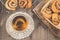 glass cup of tea and rolls with poppy in a wooden basket/glass cup of tea and rolls with poppy in a wooden basket on a dark wooden