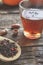 glass cup with tea and wooden spoonful of berry herbal tea