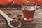 glass cup with tea and wooden spoonful of berry herbal tea