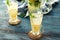 Glass cups of fresh lemonade on wooden table