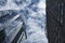 The glass curtain wall of the office building has the shadow of blue sky and white clouds