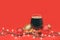 Glass of dark ale or porter beer with christmas lights and baubles on red background