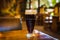 Glass with dark types of craft beer on a wooden bar. Glasses of different types of draft beer in a pub