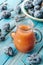 A glass decanter of fresh Damson plum juice