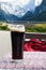 A glass of delicious dark Austrian beer against the backdrop of the European Alps in a restaurant.