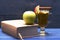 Glass of delicious glintwein with apple and book