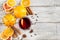 Glass of delicious mulled wine with oranges anise cinnamon on white wooden table