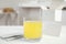 Glass with dissolved drug and medicine sachets on table indoors