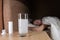 Glass with a dissolving tablet on a bedside table. a girl waiting in bed