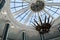 Glass dome, the roof of a building with many windows and beautiful columns, with a chandelier against a blue sky