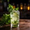 a glass of drink with ice and lime on a wooden surface