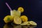 Glass of drink made with lemon on dark and mirrored background