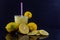 Glass of drink made with lemon on dark and mirrored background
