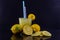 Glass of drink made with lemon on dark and mirrored background