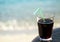 A glass of drink near the beach