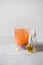 Glass dropper bottle with essential oil and medical hot tea, omega capsule on grey background. Homeopathy concept