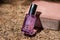 Glass dropper bottle of moisturizing serum on a stone on fallen dry pine tree needles. Anti-aging skin care. Copy space