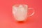 The glass is empty after kefir. Glass cup with a double bottom on a pink background.