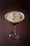 Glass of espresso martini with coffee beans and vodka on elegant