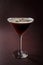 Glass of espresso martini with coffee beans and vodka on elegant