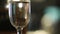 Glass filled with sparkling champagne on a restaurant table