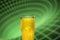 A glass filled with a yellow energy drink, isolated on a technogenic background