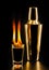 Glass of flaming alcoholic drink, vodka or liquor on fire, black background