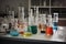 glass flasks, beakers, and test tubes arranged neatly on laboratory table