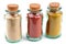 Glass flasks of paprika, curry and ginger in closeup on white background
