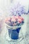 Glass flower pot with lovely pink flowers on windowsill