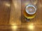 Glass of fresh cold draught beer on wood table with beautiful natural lighting