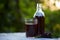 Glass of fresh elderberry syrup and elderberries