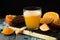 Glass of fresh orange juice,ripe orange fruit and slices on rustic wooden table.Freshly squeezed orange juice with drinking straw,