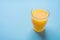 Glass of Freshly Pressed Orange Citrus Juice on Light Blue Background. Freshness Healthy Drink Detox Breakfast Morning