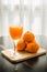 Glass of freshly pressed orange juice with four orange