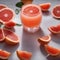 A glass of freshly squeezed grapefruit juice with a wedge of grapefruit as garnish3