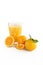A glass of freshly squeezed orange juice with orange fruit.