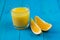 Glass of freshly squeezed orange juice and two slices of orange