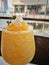 A glass of frosty orange with honeycomb on top. with salt on the glass rim.