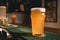 Glass of frothy wheat unfiltered beer on bar counter in pub