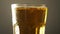 Glass full light craft beer close up spin with drop of condensation cold drink