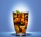 In a glass glass a soft drink with ice and mint