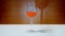Glass goblet fills with orange liquid