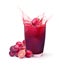 Glass of grape juice splashing with grape fruit