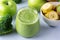 Glass of Green Healthy Smoothie with Banana Broccoli Green Apples Blue Background Close Up Above Horizontal