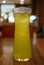 Glass of green ice tea on blurred background