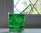 Glass with green soda aerated water