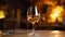 Glass of green wine in a candle lit restaurant. Romantic restaurant with a glass of white wine standing on a table. Composition of