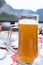 A glass of Hallstatt local beer on the table at a romantic restaurant beside the Hallstattersee Lake in High Alps Mountain
