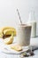 Glass of healthy banana and seeds smoothie
